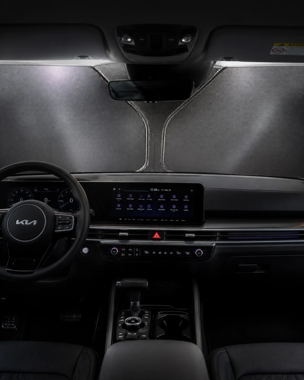 Interior view of a Kia Sorento with a sunshade installed and a cool atmosphere